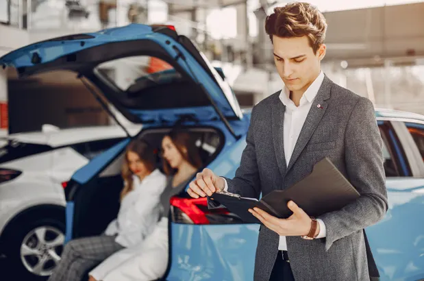 Car buyer reviewing financing details with an advisor