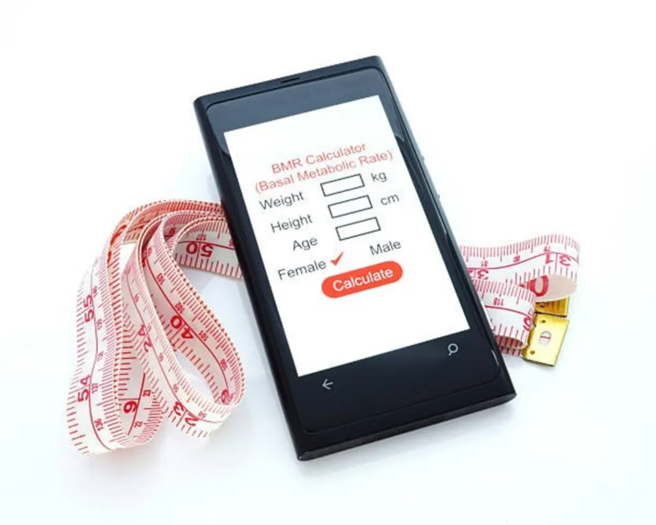 BMR calculator app on phone with tape measure