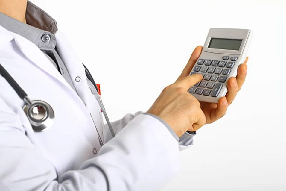 Doctor holding calculator