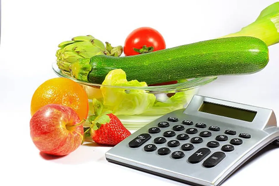 Fresh fruits vegetables with calculator