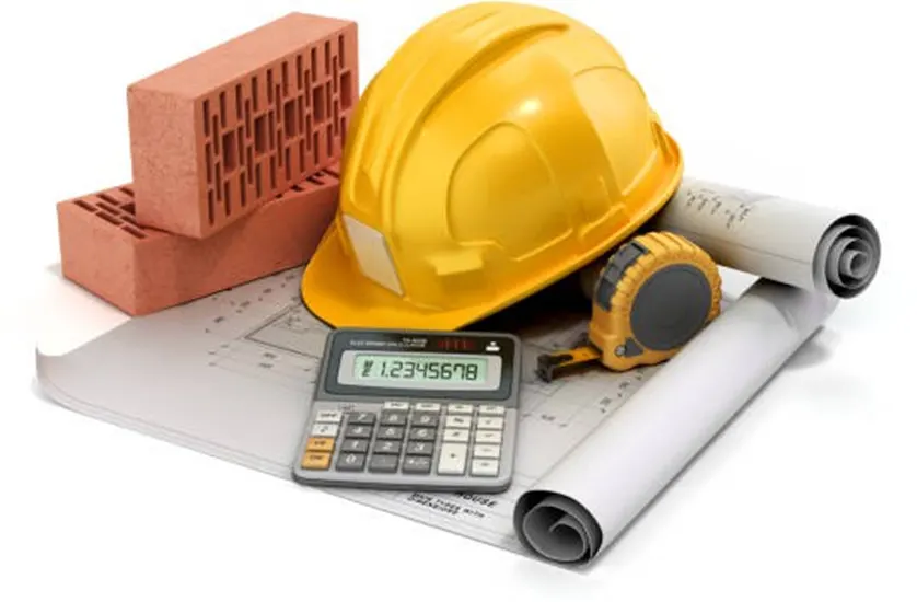 Yellow hard hat, bricks, calculator, tape measure, and blueprints on a white background