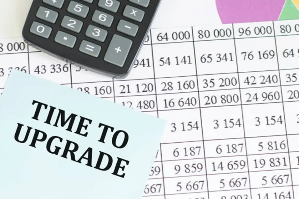 Time to Upgrade note beside a calculator and grade score spreadsheet