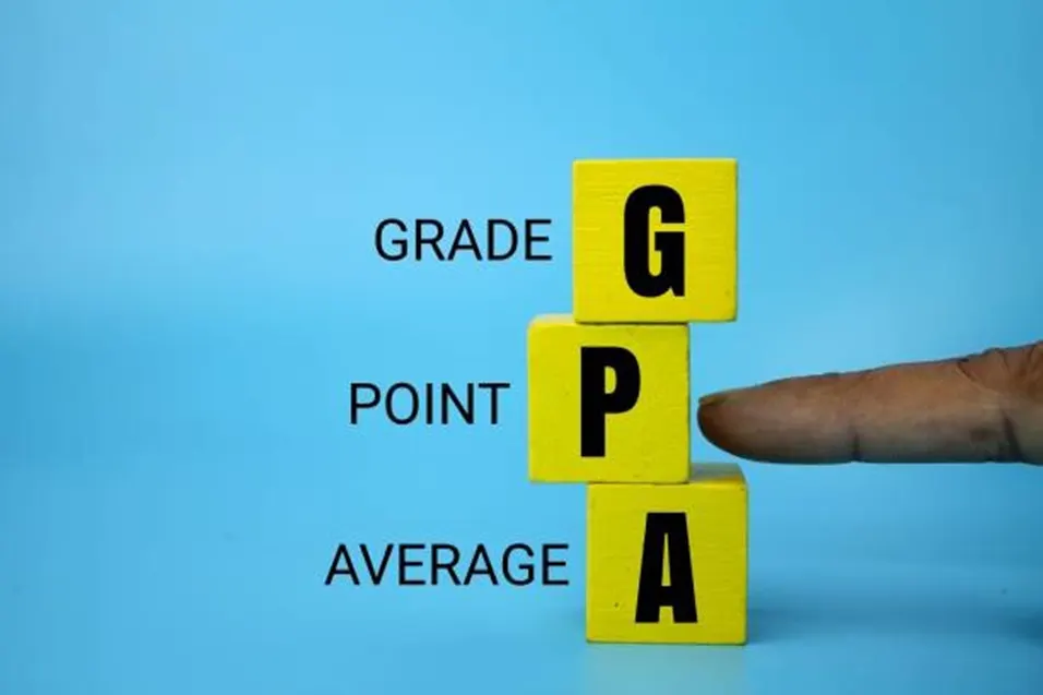 Finger pointing at yellow letter blocks spelling GPA with Grade Point Average labels on a blue background
