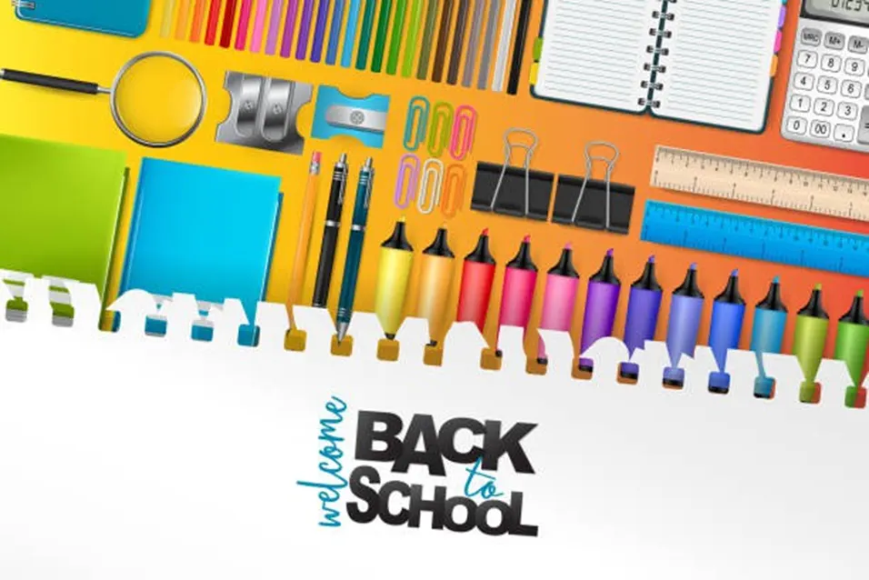 Colourful back-to-school stationery flat lay including markers, pens, rulers, notebooks, and a calculator on yellow and orange background