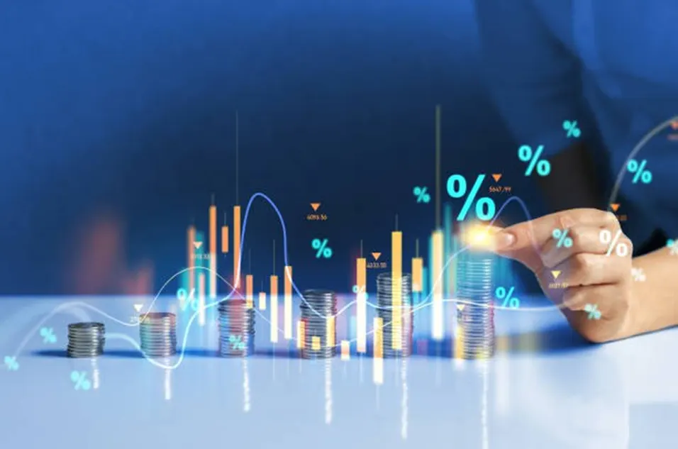 Stacks of coins rising in height with glowing candlestick charts and percentage symbols above them, touched by a finger