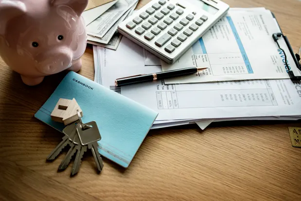 Mortgage documents with piggy bank and keys